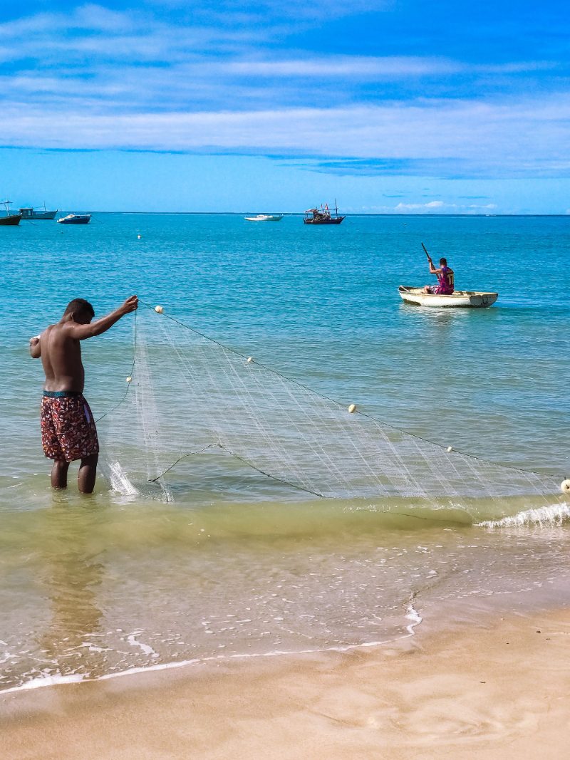 Pescador lançando a tarrafa no mar